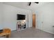 Bright bedroom with neutral carpet, ceiling fan, TV, and white storage shelves at 7435 Ansley Park Way, Cumming, GA 30028