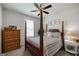 Comfortable bedroom with a four-poster bed, neutral tones, and natural light at 7435 Ansley Park Way, Cumming, GA 30028