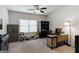 Versatile bedroom with ceiling fan, ample natural light, and neutral carpet, ideal for a home office at 7435 Ansley Park Way, Cumming, GA 30028