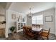 Classic dining room with a wood table set for six and natural light streaming in at 7435 Ansley Park Way, Cumming, GA 30028