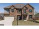 Charming two-story brick home with a well-manicured lawn and attached two-car garage at 7435 Ansley Park Way, Cumming, GA 30028