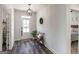 Hallway with wooden bench, entry door, and hard wood floors at 7435 Ansley Park Way, Cumming, GA 30028