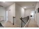 Upstairs hallway featuring carpet flooring and natural light, providing access to bedrooms and other living spaces at 7435 Ansley Park Way, Cumming, GA 30028