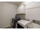 Functional laundry room featuring modern washer and dryer and ample storage cabinets at 7435 Ansley Park Way, Cumming, GA 30028