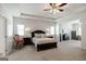 Spacious bedroom with tray ceilings, carpet, and a sitting area at 7435 Ansley Park Way, Cumming, GA 30028