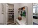 Functional mud room with custom storage, bench, and hooks, conveniently located near the main living area at 7435 Ansley Park Way, Cumming, GA 30028