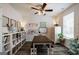 Bright, cheerful office space with long table, bookshelves, and modern ceiling fan at 7435 Ansley Park Way, Cumming, GA 30028