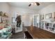 This bright office area features white bookcases and french doors to welcome guests at 7435 Ansley Park Way, Cumming, GA 30028