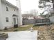 Backyard featuring a stone fire pit, deck, and lush landscaping at 7564 Mountain Ridge Ln, Lithonia, GA 30058