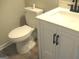 Cozy bathroom featuring a modern toilet, vanity with countertop and black hardware at 7564 Mountain Ridge Ln, Lithonia, GA 30058