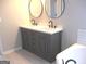 Bathroom with a modern gray double sink vanity and dual black framed mirrors at 7564 Mountain Ridge Ln, Lithonia, GA 30058