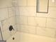 The bathroom features a tub with bright marble tile and a built-in shelf at 7564 Mountain Ridge Ln, Lithonia, GA 30058