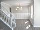 Well-lit dining room with modern light fixture, wainscoting and multiple windows at 7564 Mountain Ridge Ln, Lithonia, GA 30058