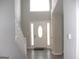 Inviting foyer with a white front door, side lights, transom window, and stairs at 7564 Mountain Ridge Ln, Lithonia, GA 30058