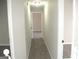 Neutral colored upstairs hallway with carpet and view into other rooms at 7564 Mountain Ridge Ln, Lithonia, GA 30058