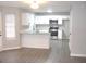 Modern kitchen featuring white cabinets, stainless steel appliances, and an island with bar seating at 7564 Mountain Ridge Ln, Lithonia, GA 30058
