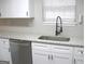 Close-up of the kitchen countertops and cabinets with stainless steel dishwasher and updated sink at 7564 Mountain Ridge Ln, Lithonia, GA 30058