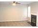 Spacious living room with a decorative fireplace and large window providing ample natural light at 7564 Mountain Ridge Ln, Lithonia, GA 30058