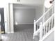 Open-concept living room view from the stairs, featuring neutral paint and plush carpeting at 7564 Mountain Ridge Ln, Lithonia, GA 30058