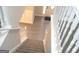 Carpeted staircase with a white railing leading to an open entryway with hardwood floors at 7564 Mountain Ridge Ln, Lithonia, GA 30058