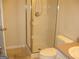 Small bathroom with a toilet and glass shower enclosure with chrome fixtures at 4000 Orchard Hill Ter, Stone Mountain, GA 30083