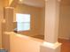 Open-concept living space featuring decorative columns and hardwood flooring for a modern feel at 4000 Orchard Hill Ter, Stone Mountain, GA 30083