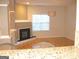 Inviting living room with fireplace, hardwood floors, and abundant natural light from large window at 4000 Orchard Hill Ter, Stone Mountain, GA 30083