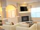 Bright living room featuring a fireplace, mounted TV, neutral decor and a half wall separating the space at 4000 Orchard Hill Ter, Stone Mountain, GA 30083
