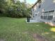 Spacious backyard featuring a patio, lush lawn and mature trees at 5627 Isleworth Ct, Atlanta, GA 30349