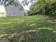 Spacious backyard featuring a patio, lush lawn and mature trees at 5627 Isleworth Ct, Atlanta, GA 30349
