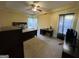 Spacious bedroom with ceiling fan, large bed, computer desk, and a dresser at 5627 Isleworth Ct, Atlanta, GA 30349
