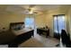 Spacious bedroom with ceiling fan, large bed, computer desk, and a dresser at 5627 Isleworth Ct, Atlanta, GA 30349
