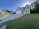 Traditional two-story home featuring a large driveway, green shutters, and well-manicured lawn at 5627 Isleworth Ct, Atlanta, GA 30349
