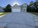 Charming two-story home with a spacious driveway and well-maintained lawn and nice green shutters at 5627 Isleworth Ct, Atlanta, GA 30349