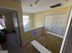 Upstairs hallway with hanging light, closet, and window with lots of natural light at 5627 Isleworth Ct, Atlanta, GA 30349