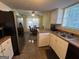 Functional kitchen featuring white cabinets, double sinks, tile floors, and breakfast table at 5627 Isleworth Ct, Atlanta, GA 30349