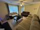 Comfortable living room with large window, ceiling fan, and comfortable sofas at 5627 Isleworth Ct, Atlanta, GA 30349