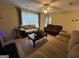 Spacious living room featuring natural light, comfortable sofas, and views of the backyard at 5627 Isleworth Ct, Atlanta, GA 30349