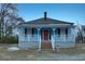Charming blue single-story home featuring a brick stairs, red front door, and white porch at 1730 Spring Ne St, Conyers, GA 30012