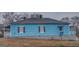 Side view of charming blue home with dark shutters and window on the side at 1730 Spring Ne St, Conyers, GA 30012