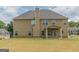 The back of this two-story home has an outdoor patio and lots of windows to allow in sunlight at 171 Osier Dr, Mcdonough, GA 30252