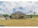 Expansive backyard view features a large, well-maintained lawn and neighboring homes in a suburban setting at 171 Osier Dr, Mcdonough, GA 30252