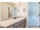 This light and bright bathroom has a granite counter and vanity with a view to a bedroom at 171 Osier Dr, Mcdonough, GA 30252