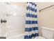 This clean, crisp bathroom features a tub/shower and blue striped shower curtain at 171 Osier Dr, Mcdonough, GA 30252