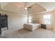 Spacious bedroom featuring a tray ceiling, ceiling fan and natural light at 171 Osier Dr, Mcdonough, GA 30252