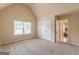 The bedroom has neutral carpet, a large window, and view to the ensuite bathroom at 171 Osier Dr, Mcdonough, GA 30252