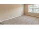 Bedroom features neutral carpet and a window at 171 Osier Dr, Mcdonough, GA 30252