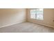 Spacious bedroom with neutral carpet and natural light from the window at 171 Osier Dr, Mcdonough, GA 30252