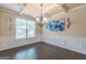 Formal dining room with a coffered ceiling, hardwood floors, wainscoting and elegant chandelier at 171 Osier Dr, Mcdonough, GA 30252