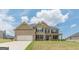 A beautifully designed house with a combination of brick and siding, complete with a spacious two-car garage at 171 Osier Dr, Mcdonough, GA 30252